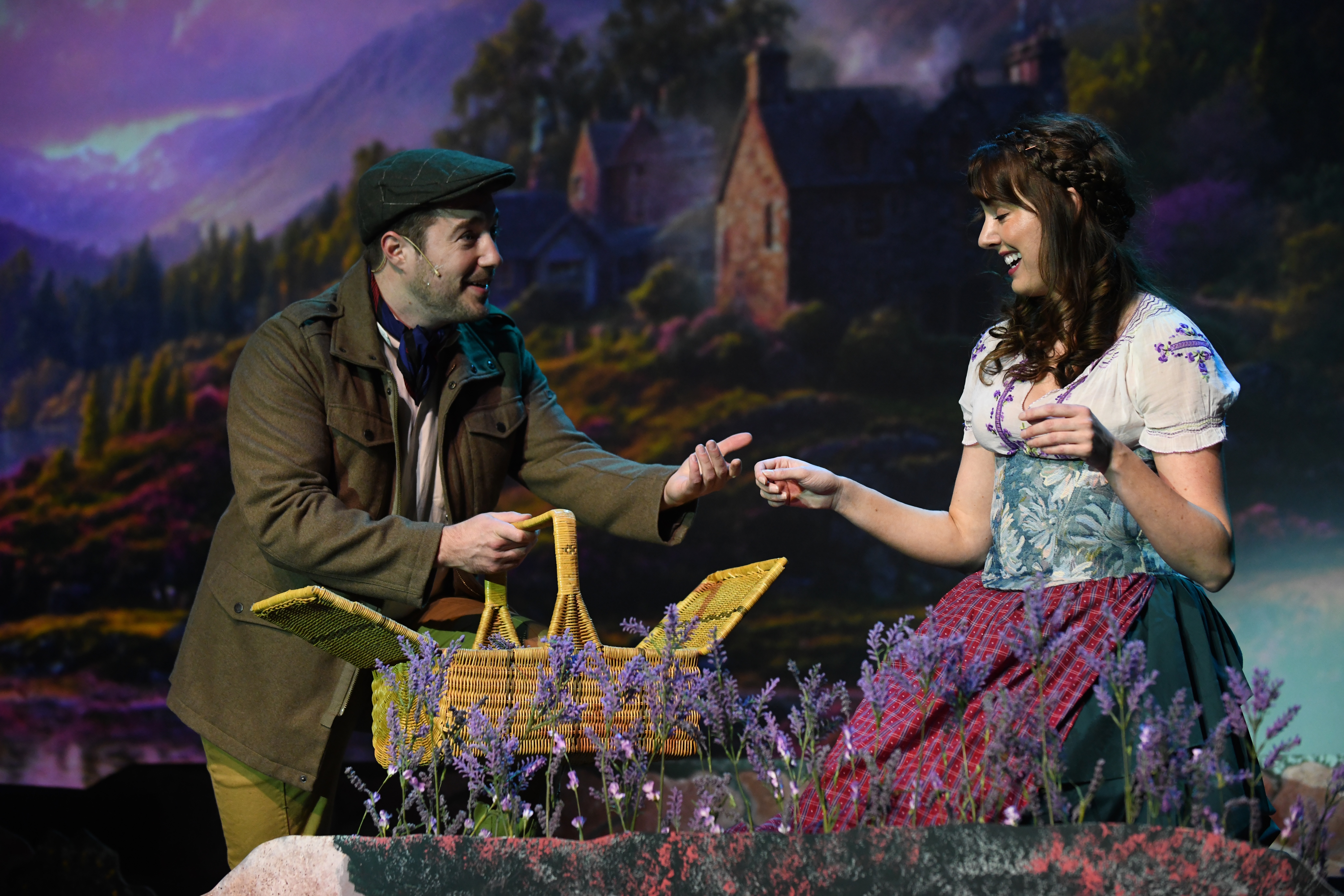 a couple picks heather on a hill